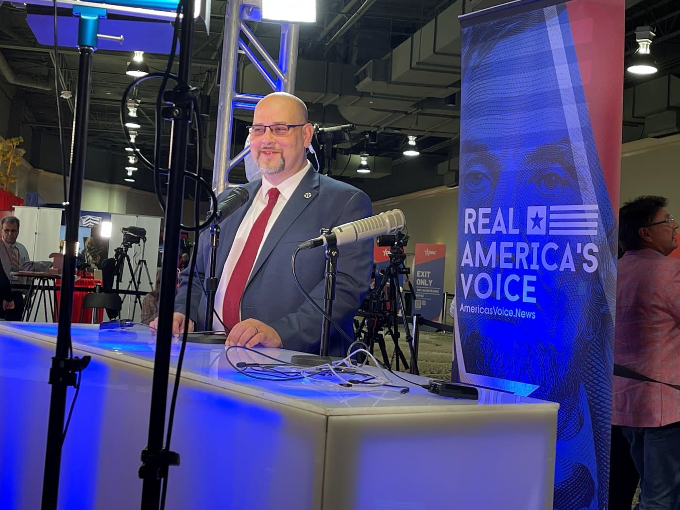 Daniel Miller broadcasting from a media set