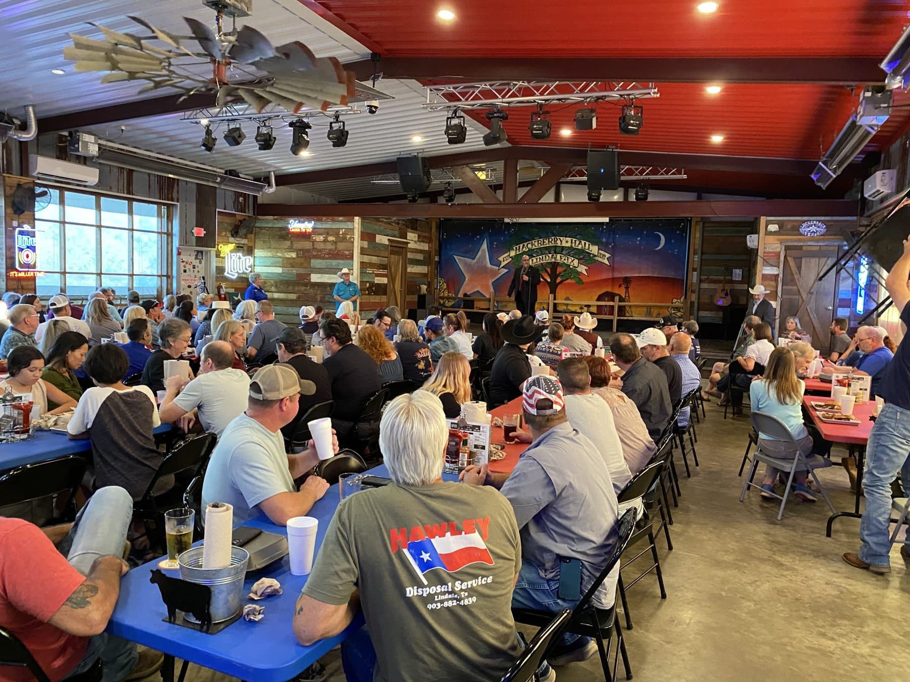 Daniel Miller addressing a town hall crowd at a Texas venue